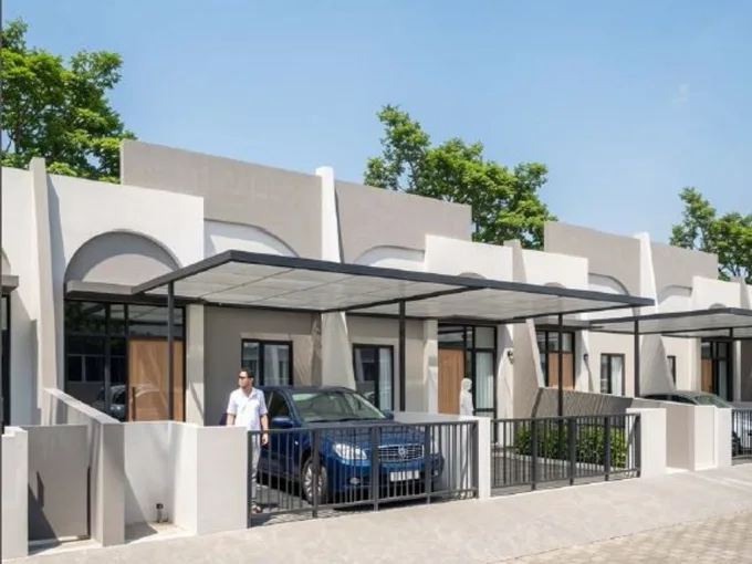 Row of Modern Townhouses with Carport Canopies a Blue Suv Parked at the Entrance a Man Nearby  Rooma21com