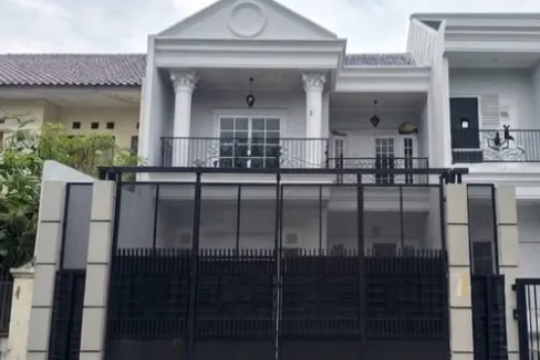 Front View of a Modern Two story White House with Classical Columns and a Tall Black Gate over a Gated Driveway  Rooma21com