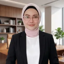 Professional Portrait of a Woman Wearing a Light Pink Hijab and Clear Glasses in a Modern Office Backdrop with Wooden Shelves and Plants in View  Rooma21com