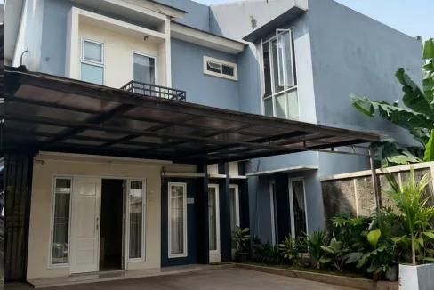Two story Blue House with a Covered Driveway Glass Doors and a Small Garden Along the Right Wall  Rooma21com