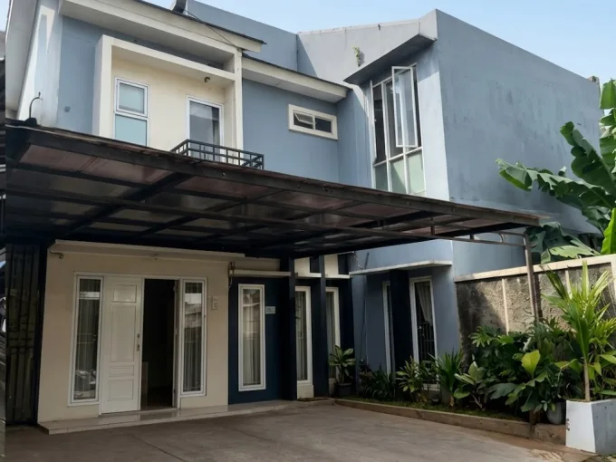 Two story Blue House with a Covered Driveway Glass Doors and a Small Garden Along the Right Wall  Rooma21com