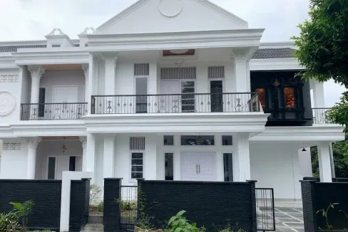 White Two story House with Classical Columns a Balcony and a Black Low Wall Fence Along the Front Yard  Rooma21com