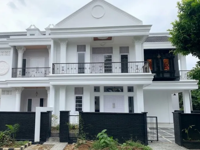 White Two story House with Classical Columns a Balcony and a Black Low Wall Fence Along the Front Yard  Rooma21com