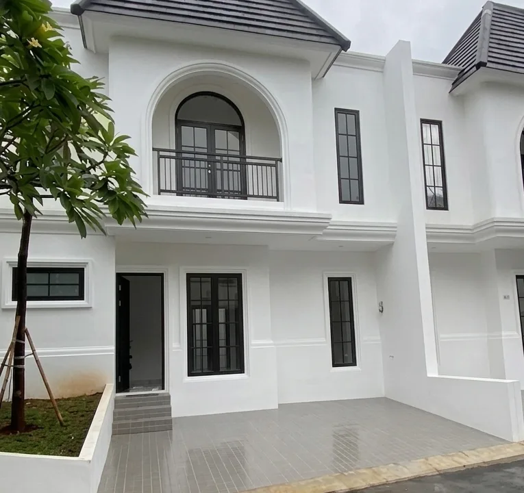 Facad Rooma21.com White Two story Townhouse with an Arched Balcony Window and Black framed Windows on a Grey tiled Front Entrance Area Tree to the Left Rooma21com