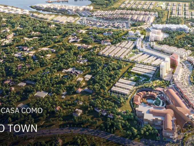 Aerial view of Vasanta Eco Town in Depok, showing green spaces, housing, and a commercial district; overlay text reads 'Commercial Lot Casa Como' and 'Heart of Depok'.